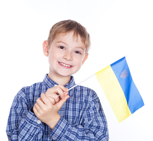 A little boy with ukrainian flag on the white background - Valokuva, kuva