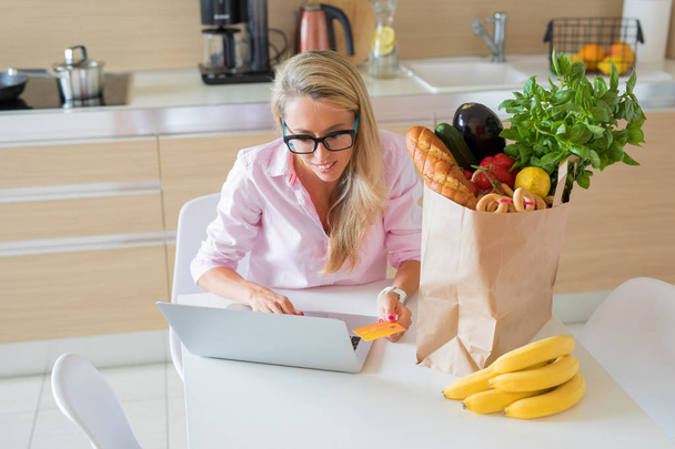 Housewife ordering groceries online and paying with credit card - Photo, Image