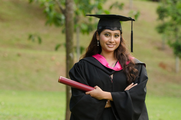 south asian female graduate with green background - Fotoğraf, Görsel