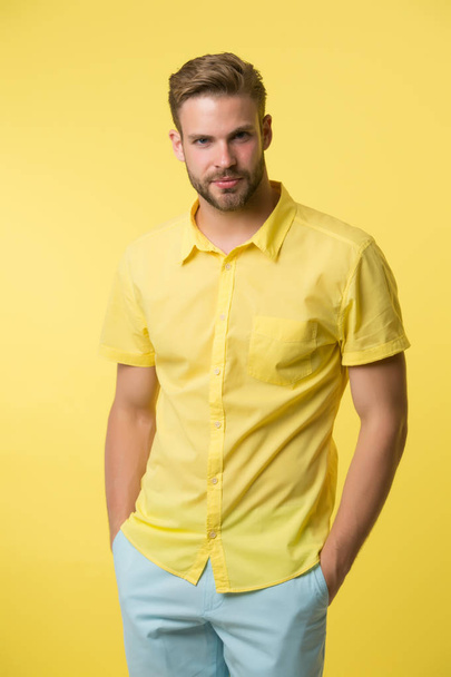 Man on calm face posing confidently with hands in pockets. Man look attractive in casual linen shirt. Guy fashion model wear casual shirt. Feel comfortable in simple outfit. Casual comfortable outfit - Fotoğraf, Görsel