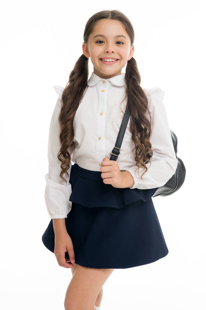 Learn how fit backpack correctly for school. Schoolgirl cute in formal uniform wear backpack. School backpack concept. Follow these tips. Right and wrong ways to wear backpack to prevent pain - Foto, imagen