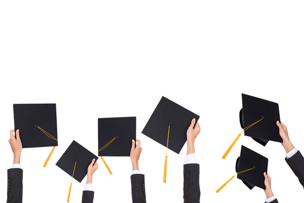 Graduation holds a black hat and a yellow tassel on white isolated background. - Foto, Imagen