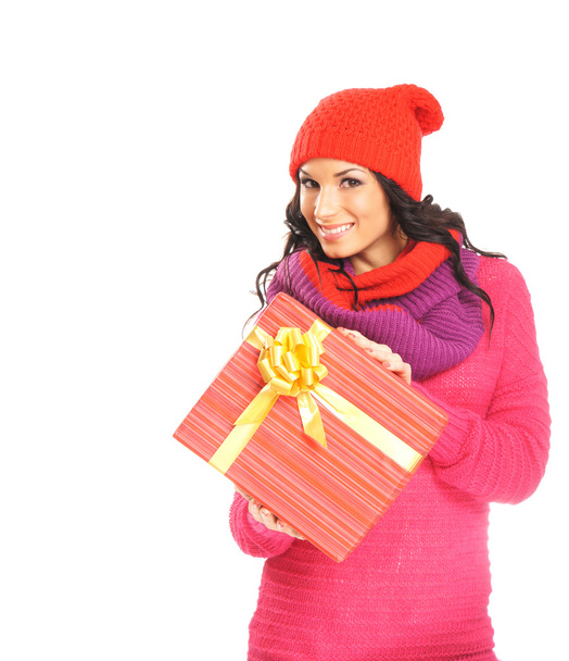 Young and beautiful woman holding a nice Christmas present over - Fotó, kép