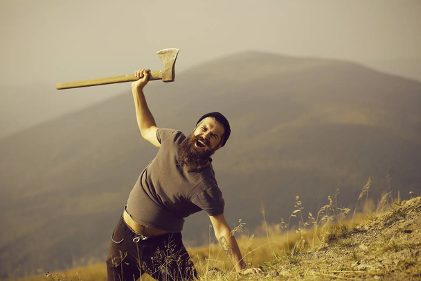 bearded man with ax on mountain - Photo, Image