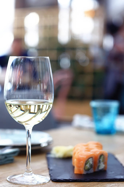 glass of white wine  on table in the restaurant  - Photo, image