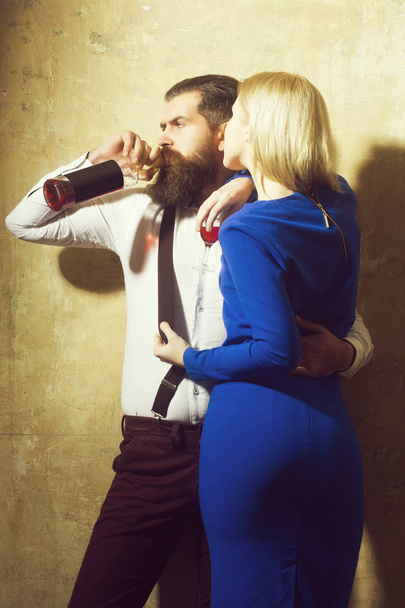 Man drinking wine from bottle and hugging girl with glass - Foto, Imagem