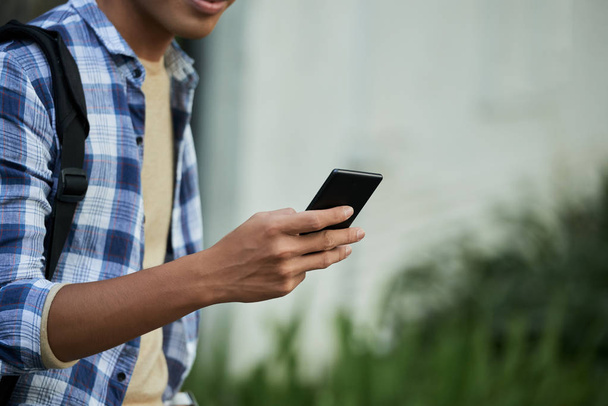 Close-up image of man browsing mobile phone  - Фото, зображення