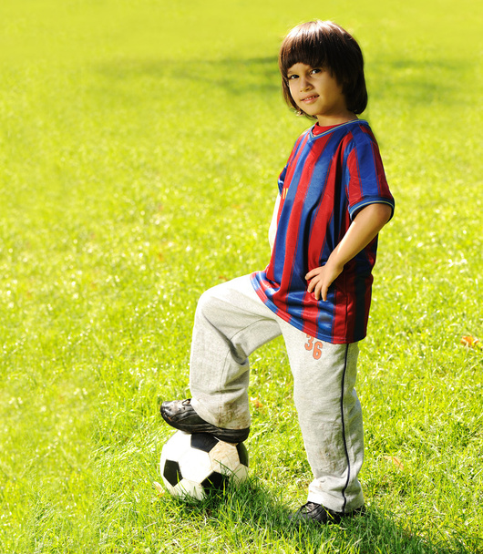 happy kid playing football in a park outdoors - Zdjęcie, obraz