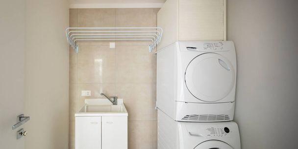 Laundry room with modern washer and dryer, nobody inside - Foto, afbeelding