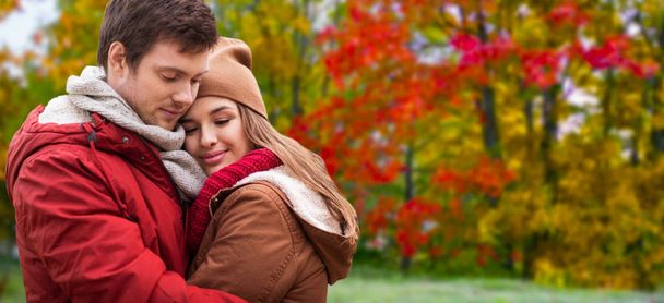 happy teenage couple hugging in autumn park - Fotoğraf, Görsel