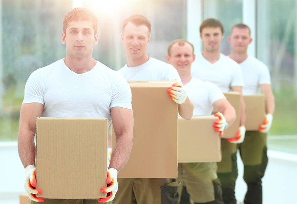 team of builders with boxes of building materials - 写真・画像