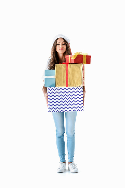 beautiful girl in santa hat holding christmas presents, isolated on white - Fotografie, Obrázek