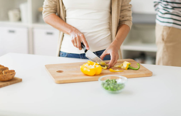 close up of woman chopping vegetables at home - Photo, image