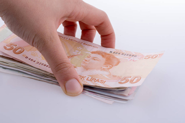 Billetes turksh lira de mano sobre fondo blanco
 - Foto, imagen
