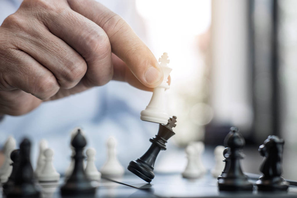 Businessman's hand playing chess game to development analysis new strategy plan, business strategy leader and teamwork concept for win and success. - Foto, Imagen
