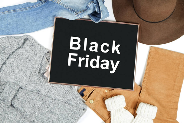 Black Friday promotion banner concept. Autumn clothing essentials for fashion boutique look book showcase. Casual set of matching garment items. Background, close up, top view, flat lay. - Photo, image