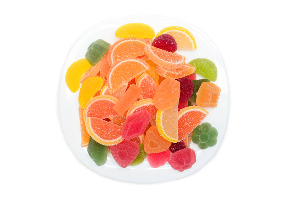 Colored fruit marmalade on the white plate. Lemon, apple, orange, grapefruit. Jelly colour background - Valokuva, kuva