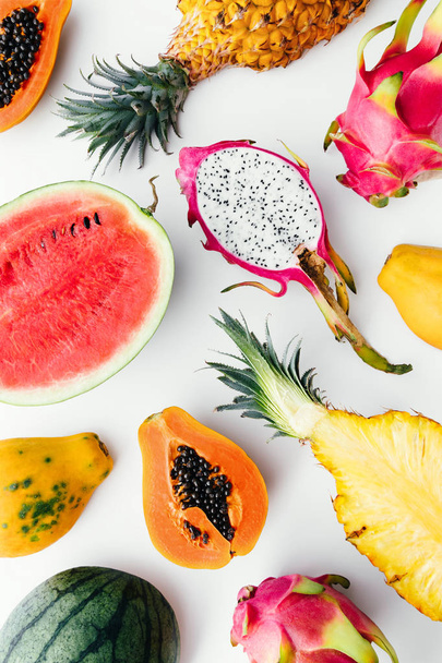 Flat lay tropical fruit layout made of dragon fruit, watermelon, papaya and pineapple. Creative summer food concept. - Фото, изображение