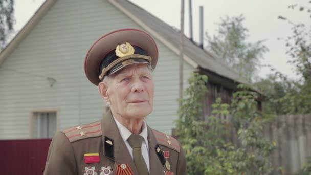 Portrait of an elderly, gray-haired veteran of world war II and world war II in military uniform - Footage, Video