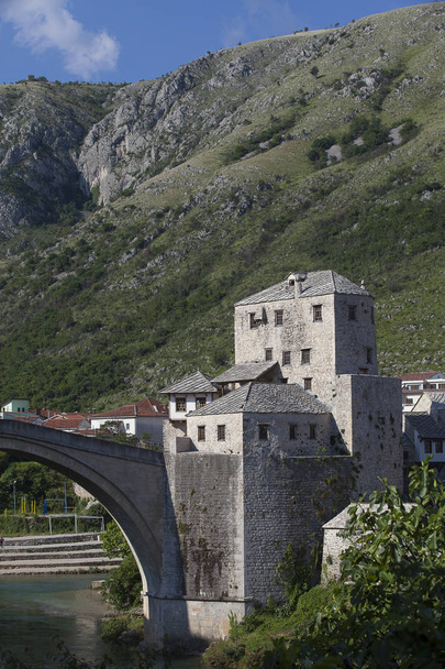 View of the single-arch Old Bridge or Stari Most crossing the Neretva River in Mostar, Bosnia and Herzegovina. The Old Bridge was destroyed on 9 November 1993 by Croat military forces during the CroatBosniak War. The area is a UNESCO World Heritage   - Photo, Image