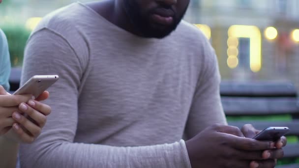Afro-american couple using smartphones, ignoring real communication, addiction - Felvétel, videó