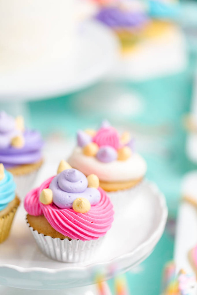 Multicolored unicorn cupcakes at little girl birthday party. - Foto, immagini