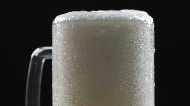 Beer foam flowing down glass walls, soft drink, pasteurized and filtered brew - Кадри, відео