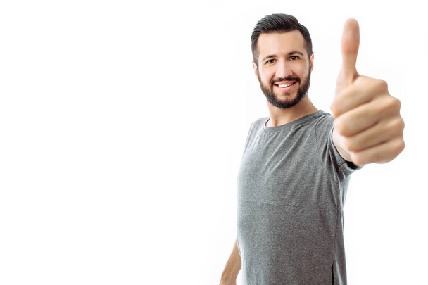 Portrait of emotional hipster man who shows class, finger, in grey t-shirt, on white background, - Photo, image