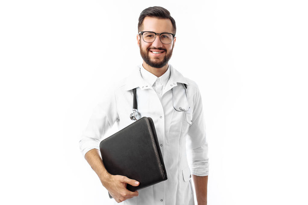 Young and handsome doctor, Intern student with folder in hand, white background, - Fotoğraf, Görsel