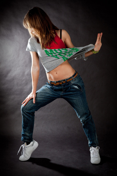 hip hop dancing girl on a dark background - Fotografie, Obrázek
