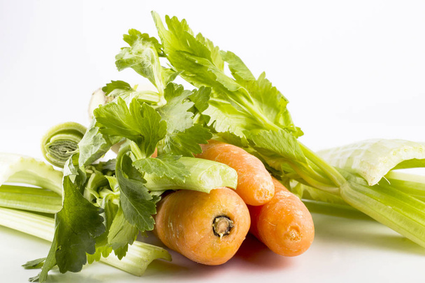 Fresh vegetables on white background, green leaves and carrots  - Valokuva, kuva