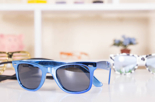stylish colorful sunglasses on table  - Foto, afbeelding