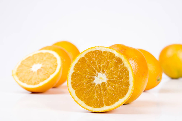 orange fruits, whole and split - Φωτογραφία, εικόνα