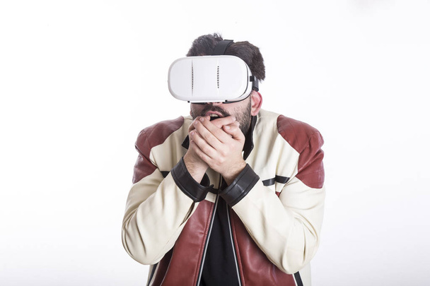 emotional gamer man wearing vr glasses in white studio  - Valokuva, kuva
