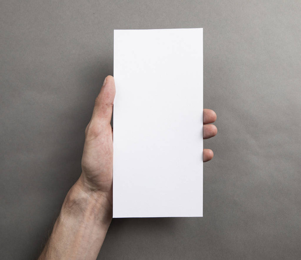 Mens hand holding white flyer - Foto, Bild