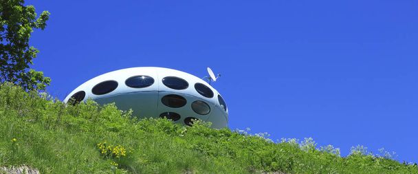 UFO against clear blue sky and Caucasus mountains landscape summertime. Dombai nature, Russian Federation - 写真・画像