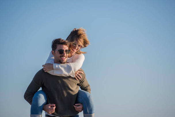 Men Giving Piggy Back Rides to his girlfriend At Sunset By The Sea, autumn time - Foto, Imagem