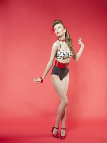 portrait of girl in pin up style on red background - Photo, Image