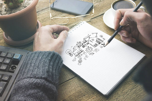 man written sketching good ideas with  stationary  on wooden table - Φωτογραφία, εικόνα