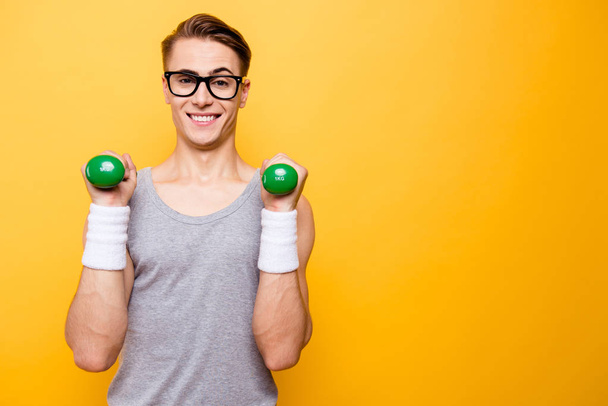 Portrait of masculinity man hold dumbbells in hands and make big - Zdjęcie, obraz