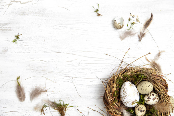 nest and eggs with text happy Easter on light wooden background, holiday concept   - Foto, Imagem