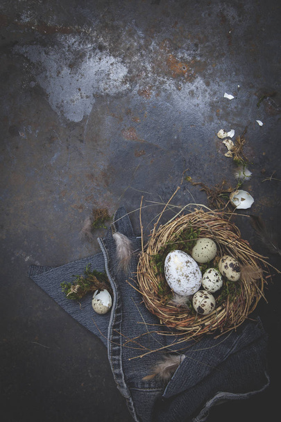 Easter decoration with nest and eggs on dark background, holiday concept   - Фото, изображение
