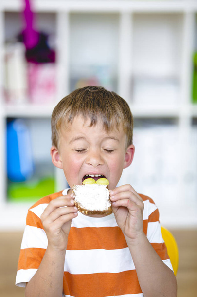 At school - Happy pupil prepare healthy snack for break - Photo, Image