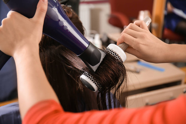 Professional hairdresser working with client in beauty salon - Photo, Image