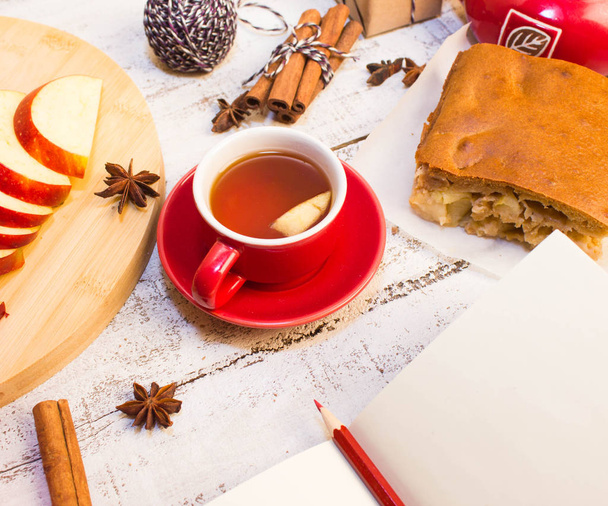 notepad, apple, tea cup  on wooden table - Zdjęcie, obraz
