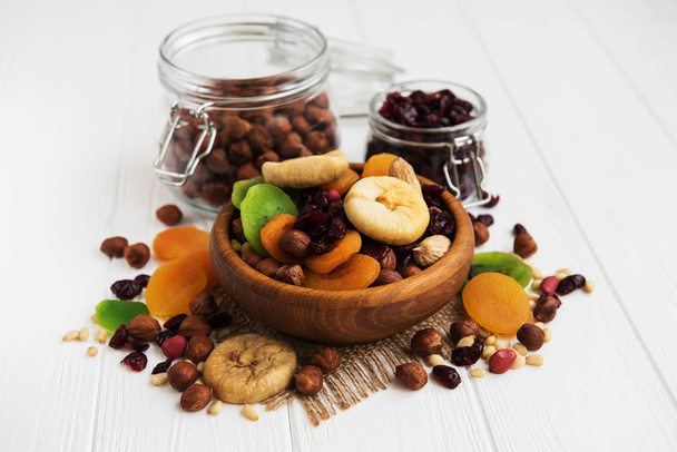 Mixed dried fruits on a old white wooden table - Photo, Image