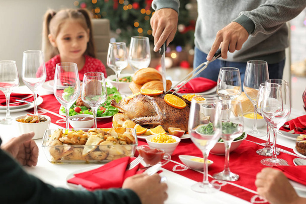 Happy family having Christmas dinner at home - Photo, image