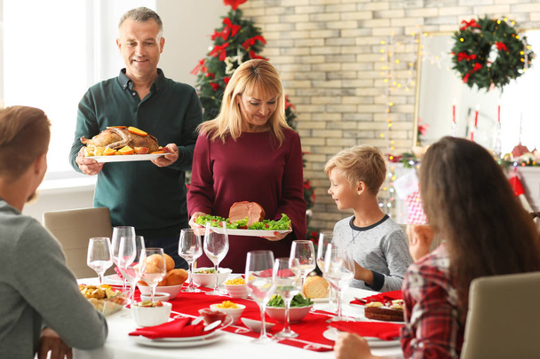 Happy family having Christmas dinner at home - Photo, Image
