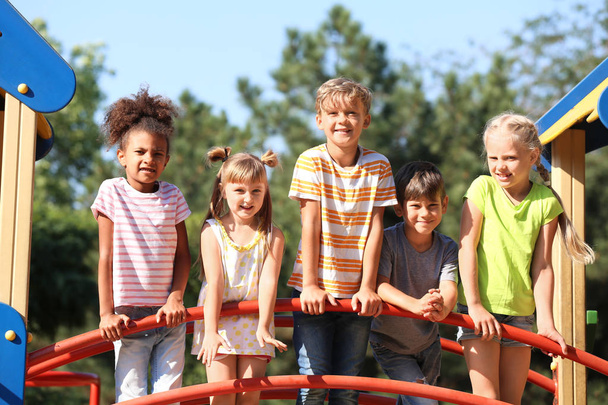 Cute little children having fun on playground outdoors - Photo, Image