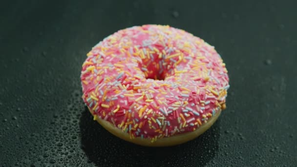 Pink donut with sprinkles  - Footage, Video